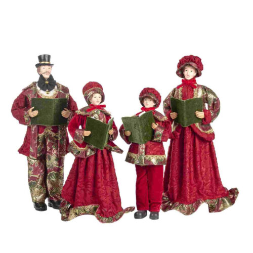 Figuras de um coro de Natal com trajes vermelhos e livros verdes.